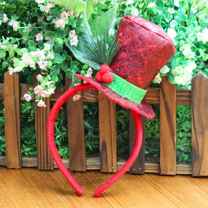 Detail of red sequin mini hat headband with green berries for Christmas festive party