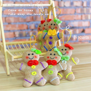 Detail of handmade felt gingerbread man ornaments with colorful decor and golden strings