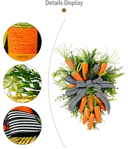 Detail view of Easter wreath with orange carrot texture and black-white striped bow