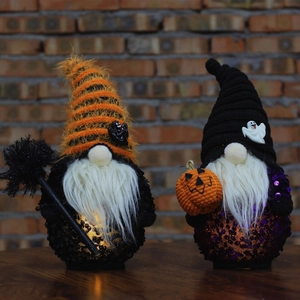 Set of two Halloween gnomes with sequins and pointed hats on a rustic wood table