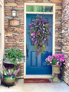 Detailed view of large purple tulip and lavender wreath on a dark entrance door