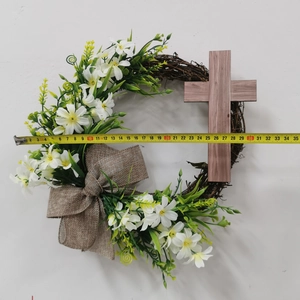 Measurement of Easter wreath with cross, white flowers and burlap bow on white background