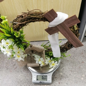 Easter cross wreath decoration on a scale showing a lightweight 160g total weight