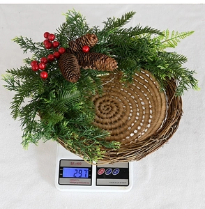 Detail showing artificial Christmas wreath basket weight of 297g on a digital scale