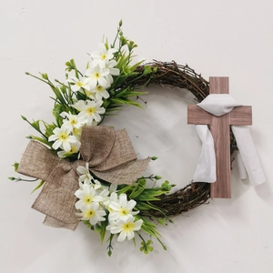 Easter cross wreath with white lilies and burlap bow on natural vine base decor