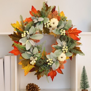 Autumn wreath with pumpkins and maple leaves for Halloween and Thanksgiving home decoration
