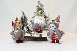 Detailed view of plush Santa, Reindeer, and Bear dolls on wooden snowflake bases