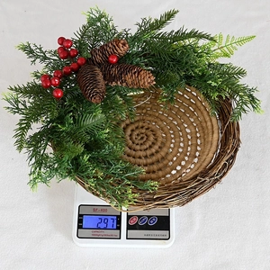 Christmas wreath with pine cones and red berries on a vine base, weighs 297g