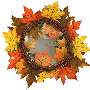 Halloween autumn pumpkin wreath with maple leaves on a natural rattan base for home decor