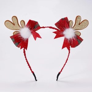 Détail d'un serre-tête bois de renne de Noël avec paillettes dorées et nœuds rouges