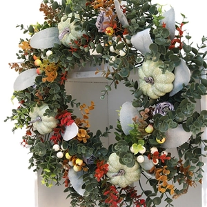 Harvest pumpkin wreath with eucalyptus leaves and berries for autumn home wall decor