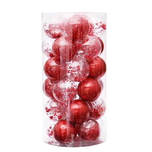 Detailed set of red Christmas balls with glitter and matte finishes in a clear cylinder box