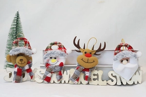 Detailed view of four plush Christmas ornaments featuring Santa, snowman, elk, and bear motifs