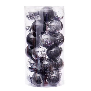 Close-up of black and transparent PET Christmas ball ornaments in a cylindrical bucket