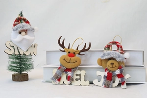 Detail of Christmas plush pendants with wood SNOW, NOEL, and JOY letters for tree decor