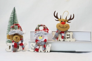 Macro detail of plush Christmas ornaments with plaid hats and cozy knit scarves