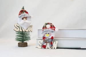 Detail of Santa and Snowman plush ornaments on wooden SNOW base for Christmas decor