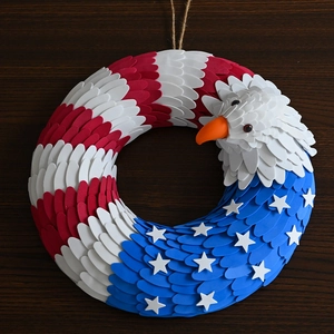 Detail of patriotic eagle wreath with red white and blue stars and stripes decor