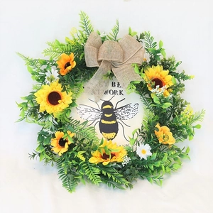 Artificial sunflower wreath with burlap bow and bee-patterned Be At Work wood sign