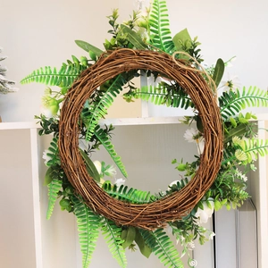 Easter egg wreath with roses and daisies on a grapevine base for home door decor
