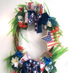 Patriotic July 4th door wreath with stars and stripes ribbon on a grapevine base