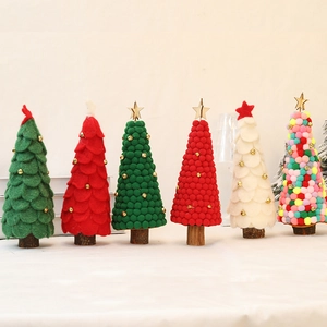 Handmade wool felt Christmas tree desk ornaments with natural wood bases in festive colors