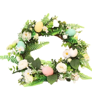 Easter wreath with artificial roses, daisies and colorful eggs for home door decoration