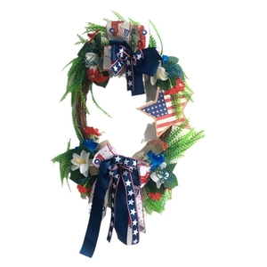 American Independence Day wreath with red white blue flowers and patriotic star bow