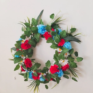 Detailed close-up of American flag colors floral wreath with red and blue flowers