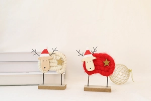 Detail of wool felt sheep Christmas ornaments with wooden heads on rectangular bases