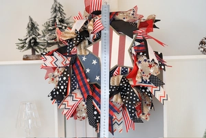 Detail shot of a 45cm patriotic American flag wreath with ribbons and a wooden star