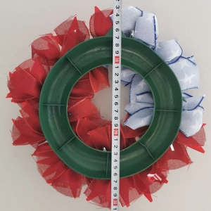 Detailed back view of patriotic wreath showing 30.5cm diameter measurement with a tape measure