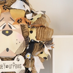 Rustic burlap wreath with Wipe Your Paws dog plaque and decorative ribbons for home decor
