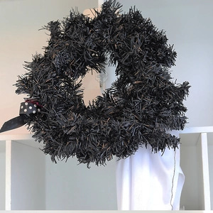 Halloween black tinsel wreath with white polka dot bow and festive ghost decoration