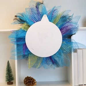 Close-up of DIY sublimation hanging ornament with colorful ribbons and black feathers
