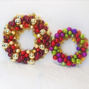Detail view of colorful festive Christmas wreaths with shiny and matte metallic ornament balls