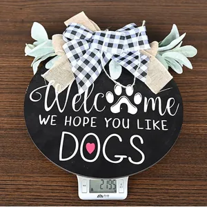 Detailed view of 219.5g wooden Welcome sign with dog paw print and rustic bow detail