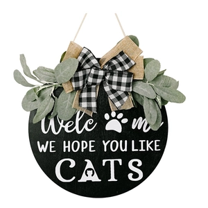 Rustic round wooden welcome sign with cat paw print and artificial greenery for wall decor