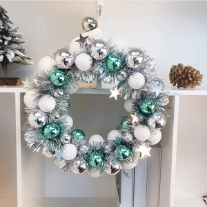 Silver and turquoise Christmas wreath with glitter balls and shiny stars for holiday decor