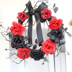 Gothic Halloween wreath with red and black roses, dried branches and black ribbon bow