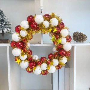 Detail of Christmas wreath with red shiny balls, white matte balls and golden stars
