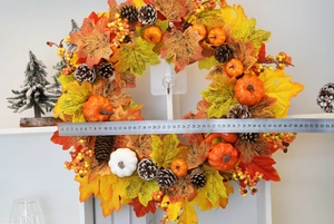 Detail shot of autumn wreath diameter measurement with pumpkins and maple leaves