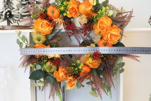 Detail view of fall pumpkin peony wreath diameter measurement with a steel ruler