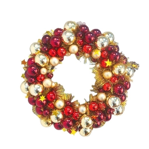 Classic red and gold Christmas wreath with shiny ornaments and metallic tinsel accents