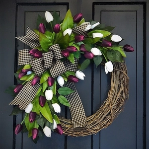 Artificial tulip wreath with purple white flowers and plaid bow on rustic rattan base