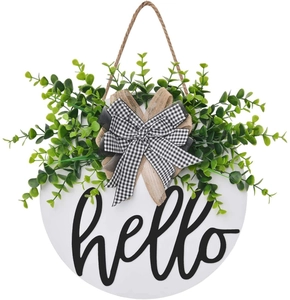 Close-up of hello welcome door sign with eucalyptus leaves and burlap bow decor