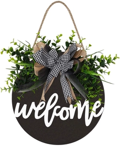 Close-up of wooden welcome sign featuring realistic green leaves and burlap bow