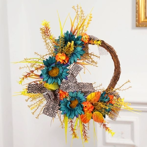 Fall sunflower wreath with blue flowers leopard ribbon and autumn leaves on rattan base