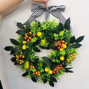 Detail of artificial lemon wreath with eucalyptus leaves and striped ribbon bow