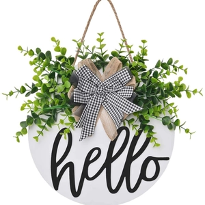 Wooden round welcome sign with hello text, eucalyptus leaves and black white plaid bow